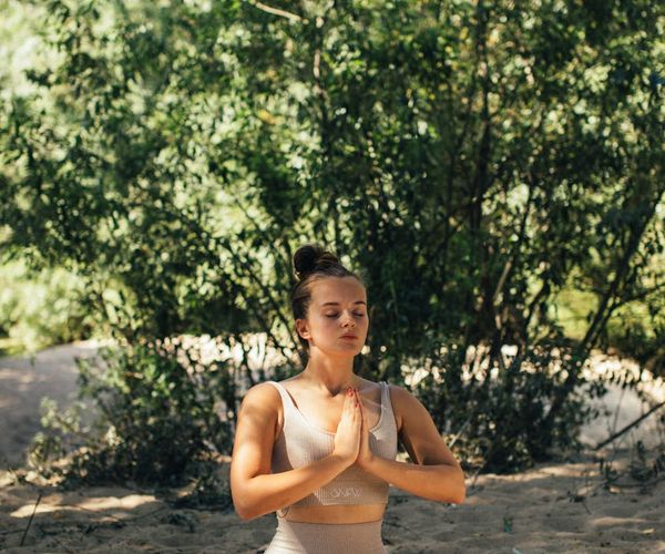 A person meditating outdoors, embodying peace and inner balance.